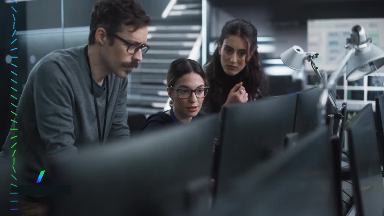 Video Thumbnail: Three people in a modern office watching computer monitors intently
